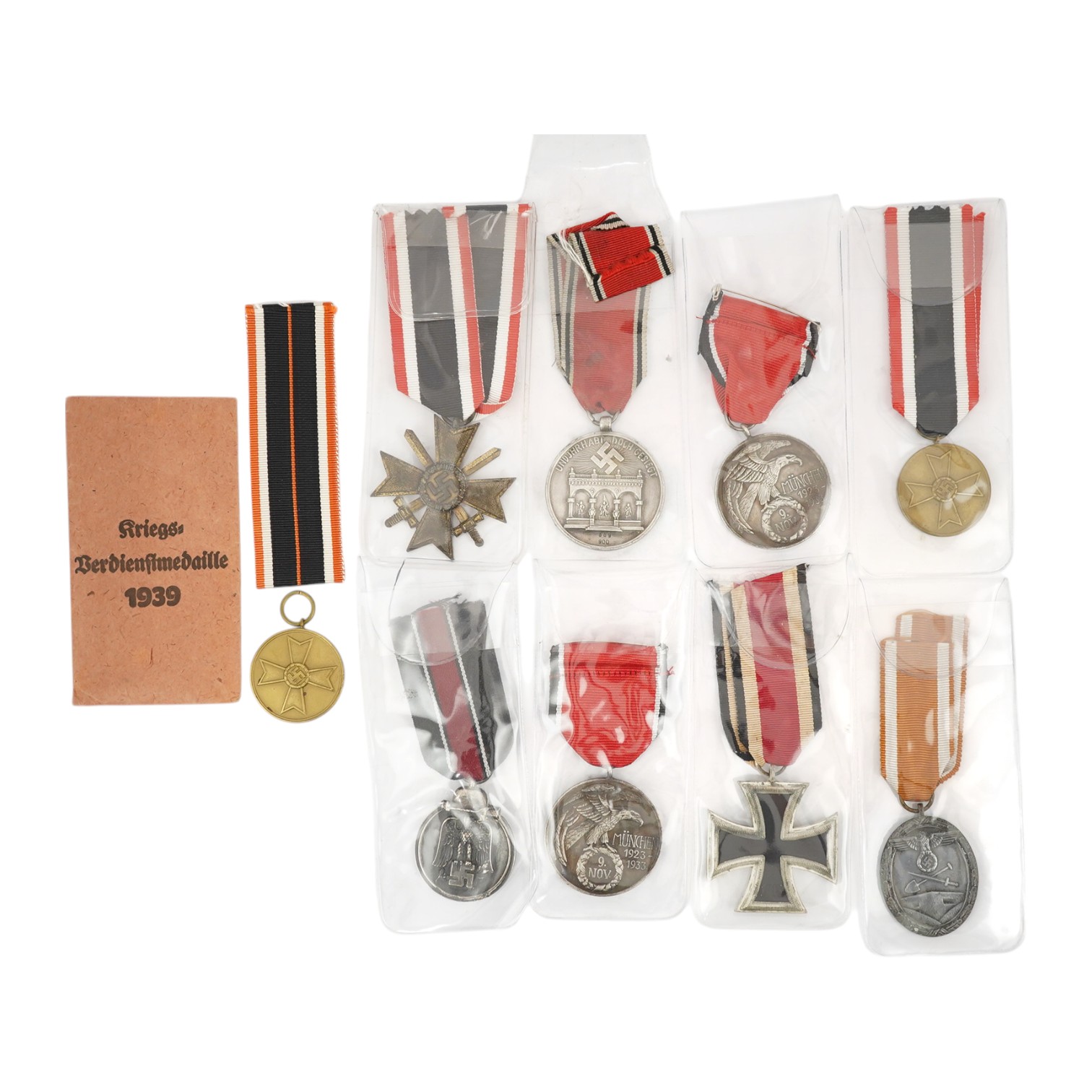 Nine German WWII medals; three Blood Order medals, a Second class Iron Cross, a War Merit medal in its original envelope, plus another unpacketed, a Second class War Merit cross, an Eastern Front Medal, and a West Wall M